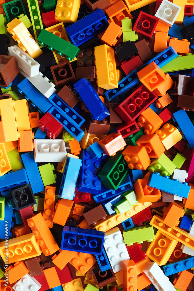 Colored toy bricks background. Pile of child's building blocks in multiple colours, top view. Colored toy bricks background. Pile of child's building blocks in multiple colours, top view.