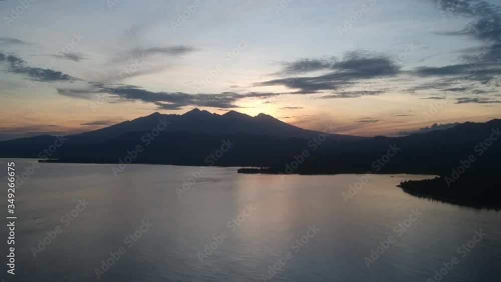 take-off on a background of a volcano on the island of Lombok Pulau Lombok West Nusa Tenggara at dawn fishing boats are visible take-off on a background of a volcano on the island of Lombok Pulau Lombok West Nusa Tenggara at dawn fishing boats are visible