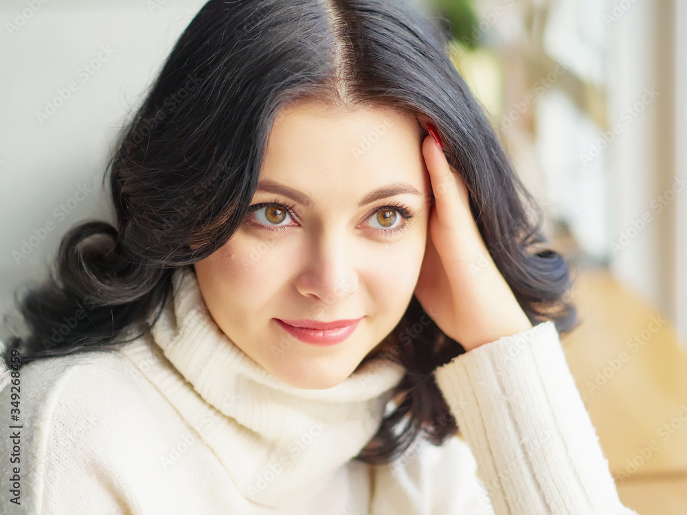 a Pretty Brunette girl in a white blouse, is sitting in a cafe. close up. copy space. a Pretty Brunette girl in a white blouse, is sitting in a cafe. close up. copy space.