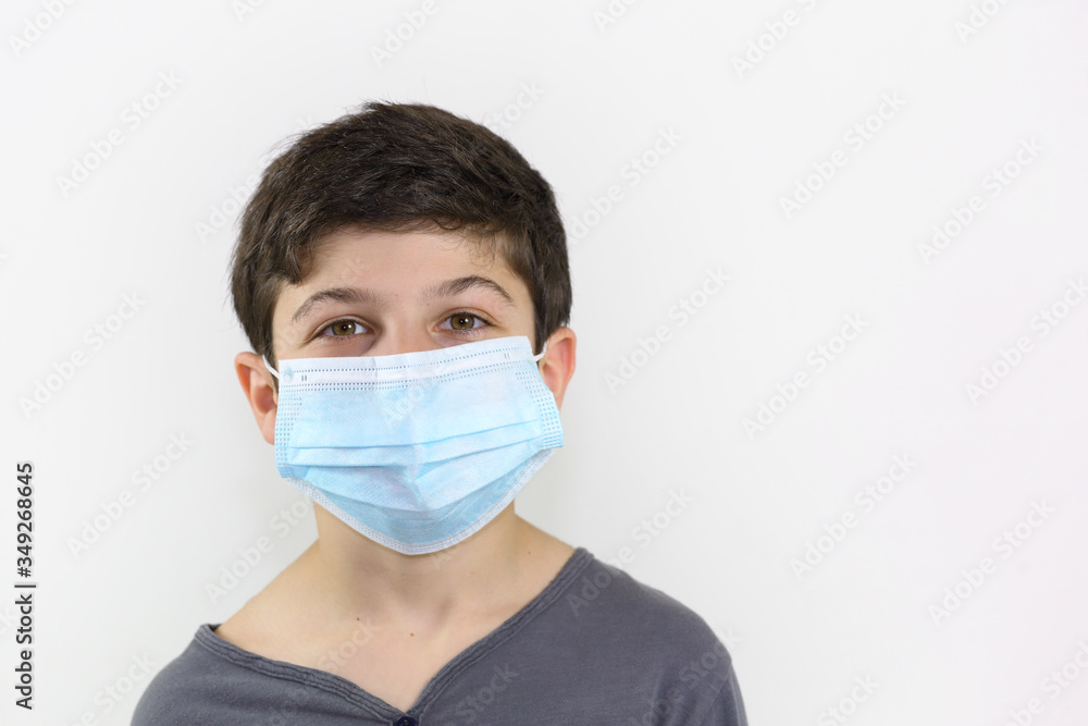Covid-19 coronavirus barrier gesture child with a surgical mask on the face Covid-19 coronavirus barrier gesture child with a surgical mask on the face