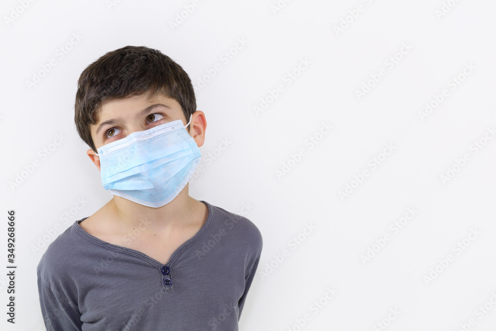 Covid-19 coronavirus barrier gesture child with a surgical mask on the face