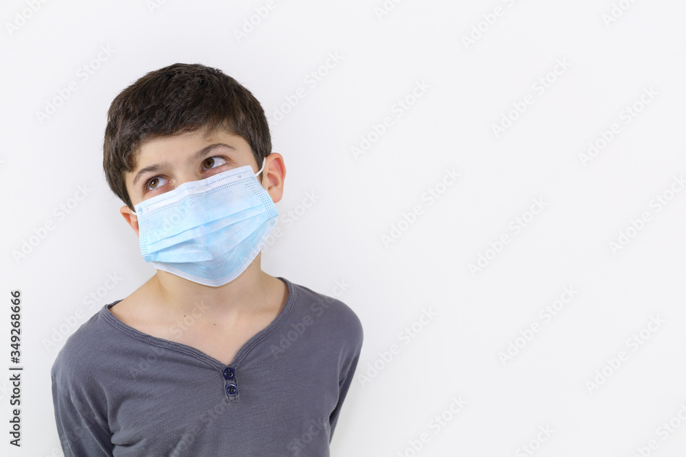 Covid-19 coronavirus barrier gesture child with a surgical mask on the face Covid-19 coronavirus barrier gesture child with a surgical mask on the face