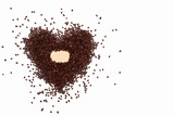 coffee beans are scattered in the shape of a heart on a white background. coffee abstraction with coffee beans in the left part of the frame. Coffee background or texture with empty space for labels