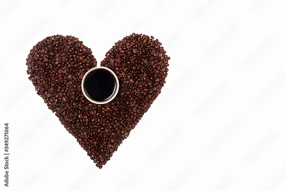a handful of heart-shaped coffee beans with a Cup of coffee in the middle. a Cup of black coffee on the background of a coffee heart. Coffee abstraction in the shape of a heart on a white background a handful of heart-shaped coffee beans with a Cup of coffee in the middle. a Cup of black coffee on the background of a coffee heart. Coffee abstraction in the shape of a heart on a white background
