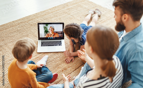 Bild auf Leinwand Family making video call to grandmother on floor.