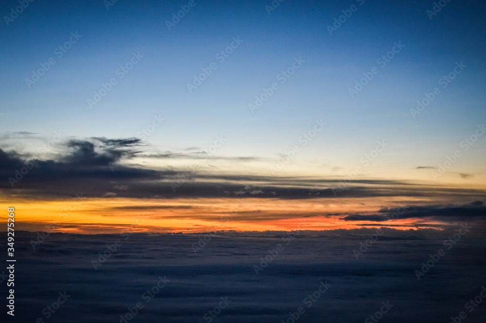 Sunset view over the clouds from an airplane