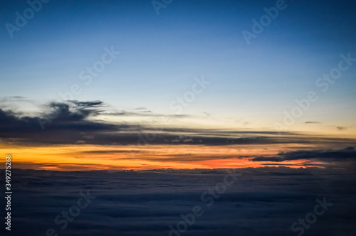 Sunset view over the clouds from an airplane © sebastianosecondi