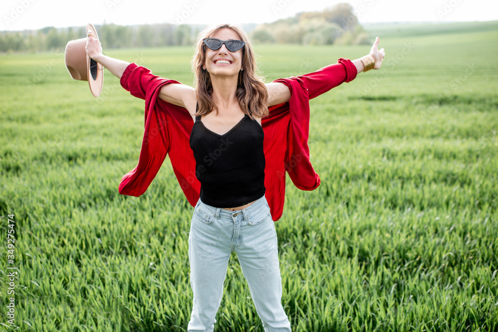 Portrait of a stylish carefree and active woman on the greenfield enjoying nature in springtime. Concept of wellness and carefree lifestyle on nature Portrait of a stylish carefree and active woman on the greenfield enjoying nature in springtime. Concept of wellness and carefree lifestyle on nature