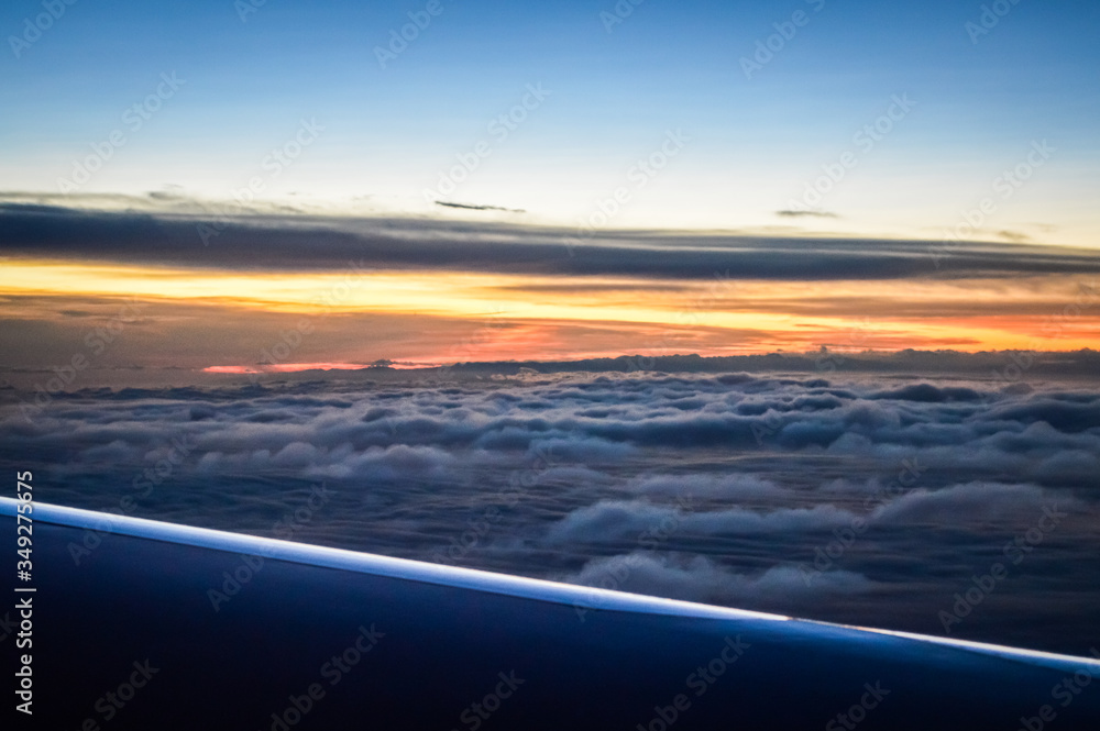 Sunset view over the clouds from an airplane