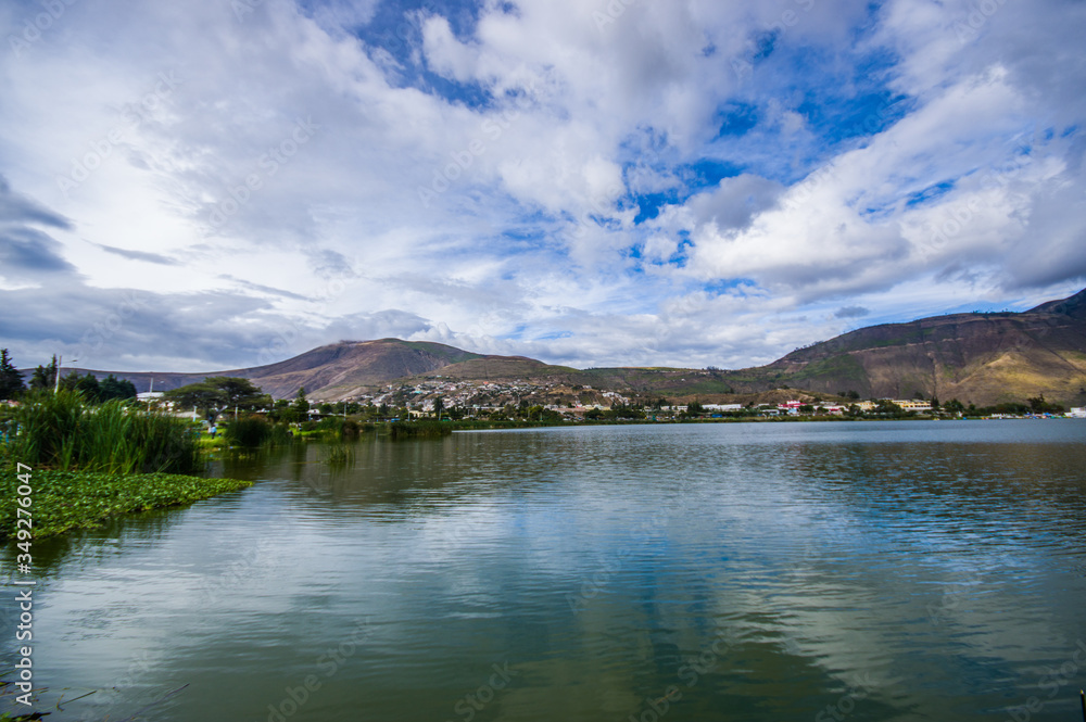Beautiful view of the lake in Yahuarcocha, in a gorgeous cloudy day with the mountain behind in Yahuarcocha Ecuador