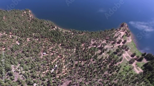 Aerial view of green trees by lake on sunny day, scenic view of forest during summer - Lake Wellington, Colorado photo