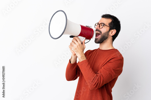 Fotótapéta Caucasian handsome man with beard over isolated white background shouting throug