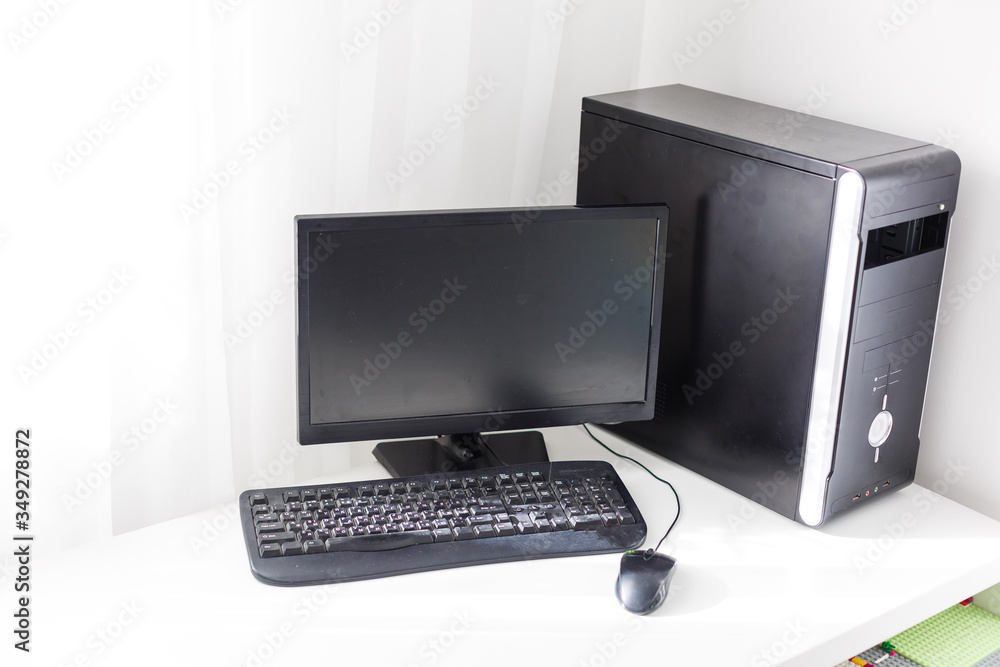 black computer with monitor are on the table at home black computer with monitor are on the table at home