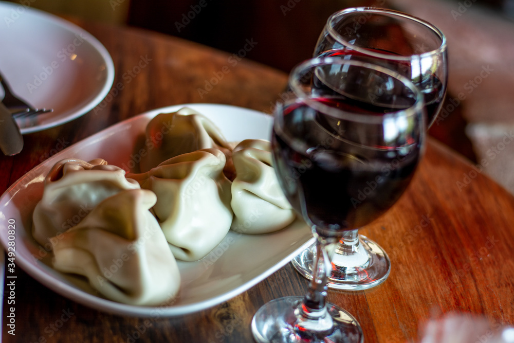 two glasses of red wine against which Khinkali lie two glasses of red wine against which Khinkali lie