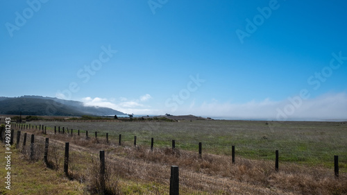 Highway 101 under the sun, with fences and fields, california © Gnac49