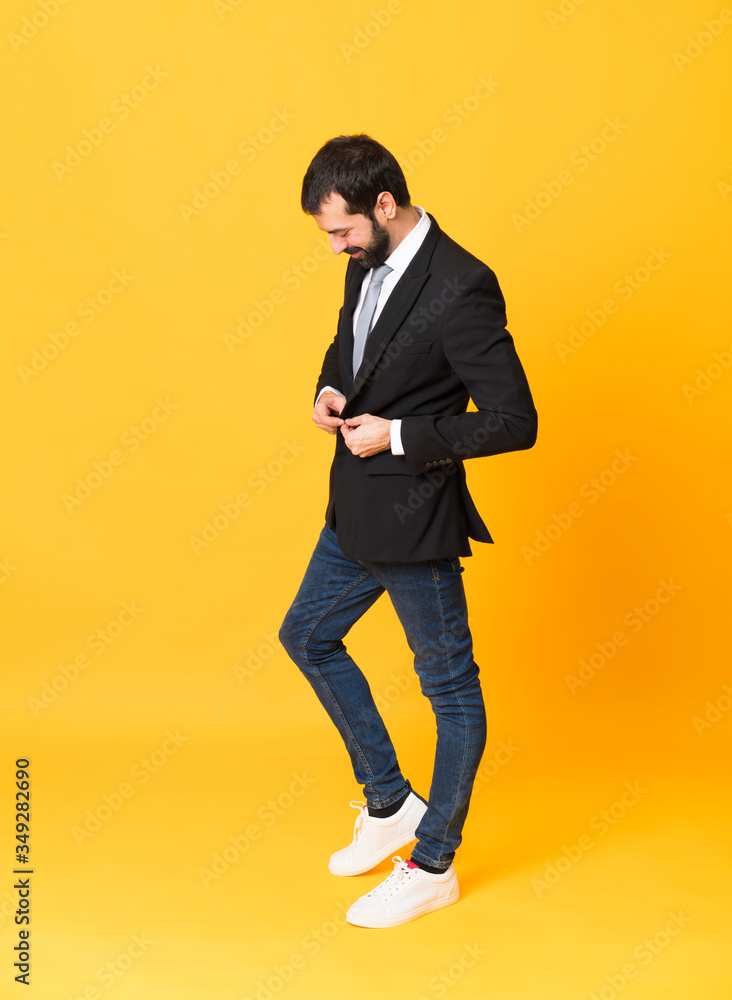 Full-length shot of business man over isolated yellow background Full-length shot of business man over isolated yellow background
