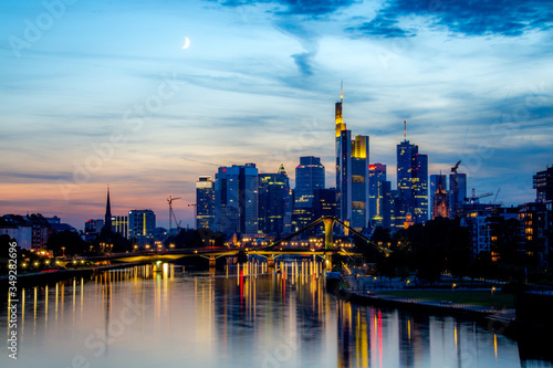 Frankfurt skyline lights at dusk with evening moon