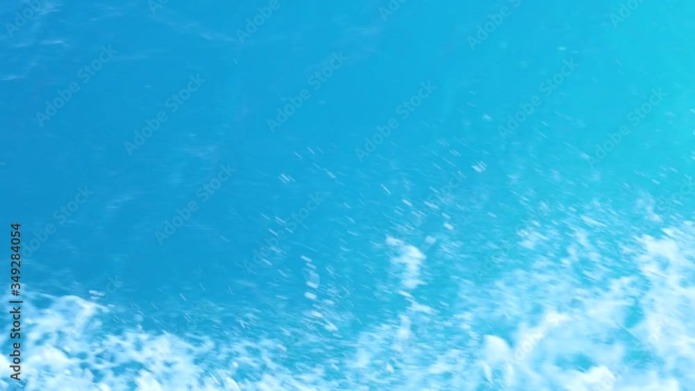 Sprays and Splashes of Pure Water Fly Up Because of a Strong Wind. Blue Waves Diverge in Different Directions From the Boat's Side. Sprays and Splashes of Pure Water Fly Up Because of a Strong Wind. Blue Waves Diverge in Different Directions From the Boat's Side.