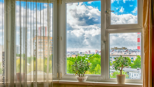 The window in the room against the backdrop of the cityscape.