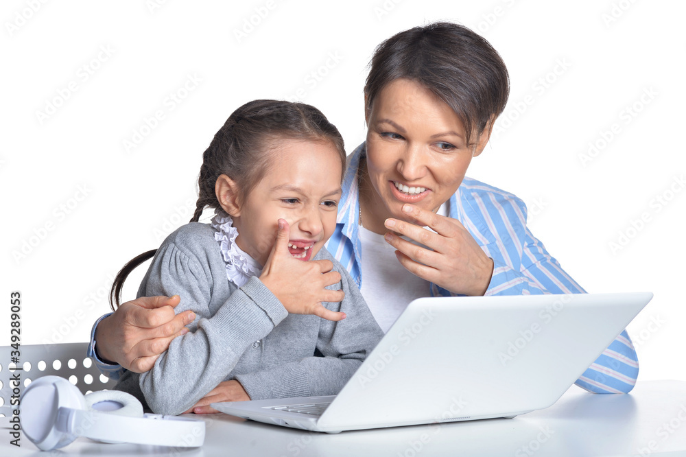 Portrait of mother and daughter using laptop posing against white Portrait of mother and daughter using laptop posing against white