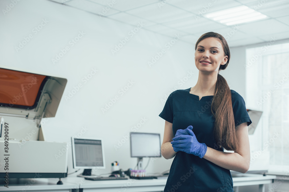 Happy woman feeling good at work in modern laboratory Happy woman feeling good at work in modern laboratory