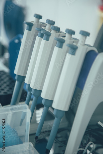 Row of blue and white variable volume pipettes