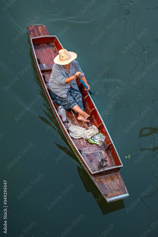 Thailand, Ratchaburi, famous Damnoen Saduak floating market in Ratchaburi. Local Woman trading fruits, food and souvenirs. very popular place among tourists from all over the world