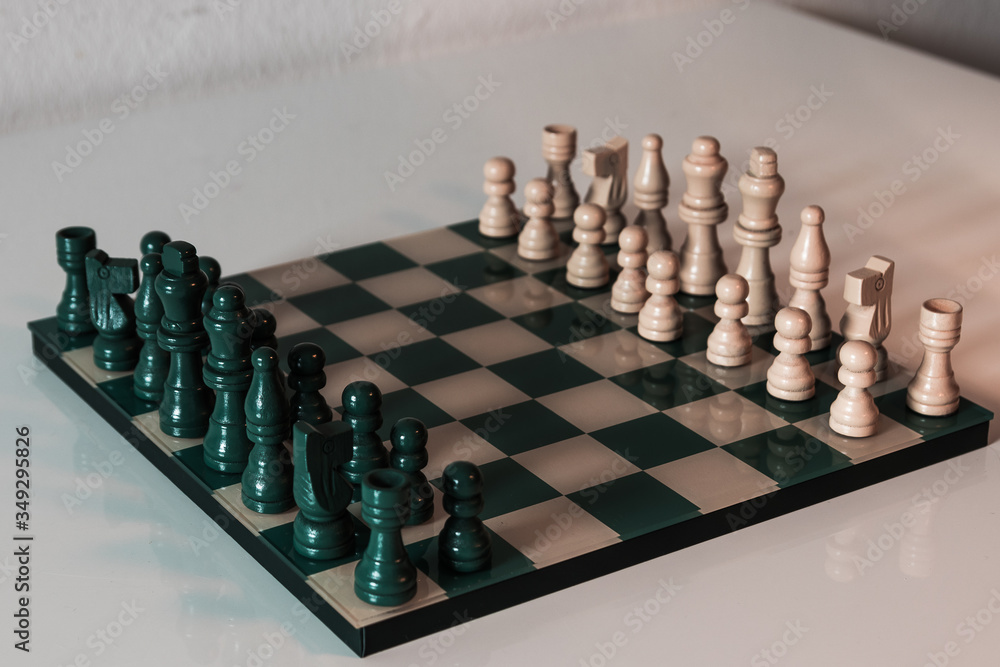 Detailed chess shot with greeny color theme. Elegant and classic boardgame.