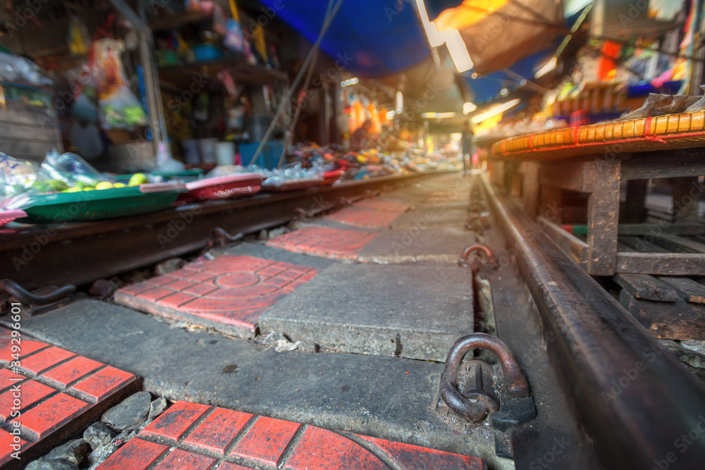 Naklejka premium .Thailand, Samut Songkhrami, Mae Klong railway market also called Siang Tai. Tourists walk along the train tracks bltkf. and make purchases from local sellers
