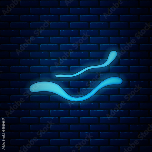 Glowing neon Ebola virus disease icon isolated on brick wall background. Vector Illustration