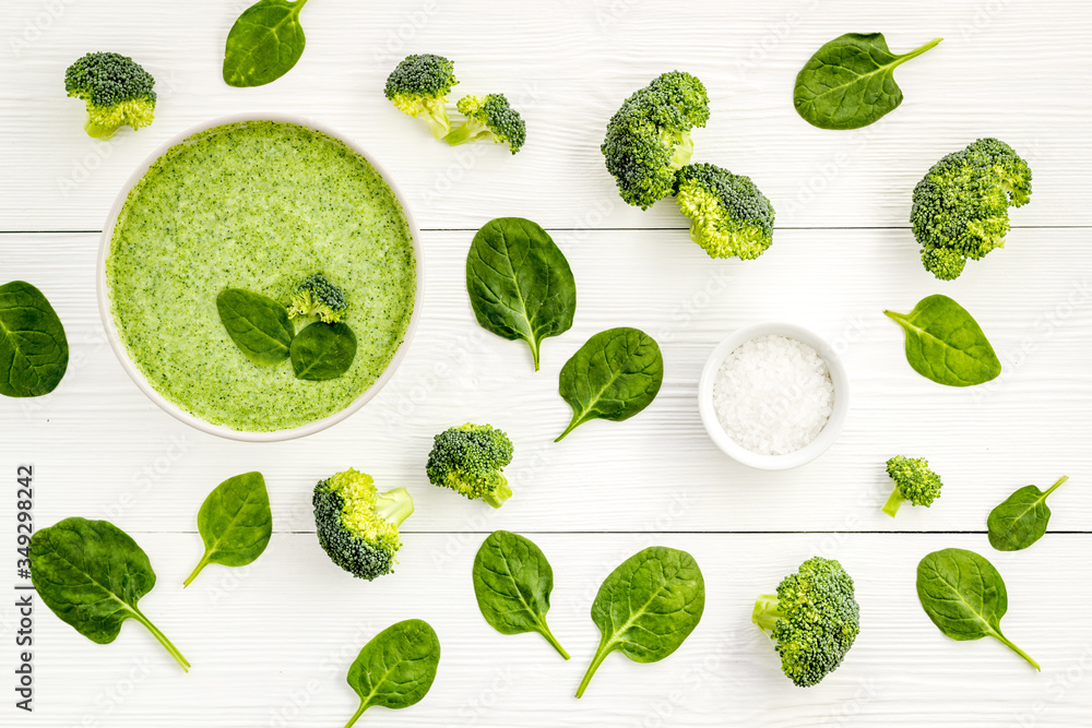 Broccoli and spinach cream soup on white desk from above. Vegetable pattern Broccoli and spinach cream soup on white desk from above. Vegetable pattern