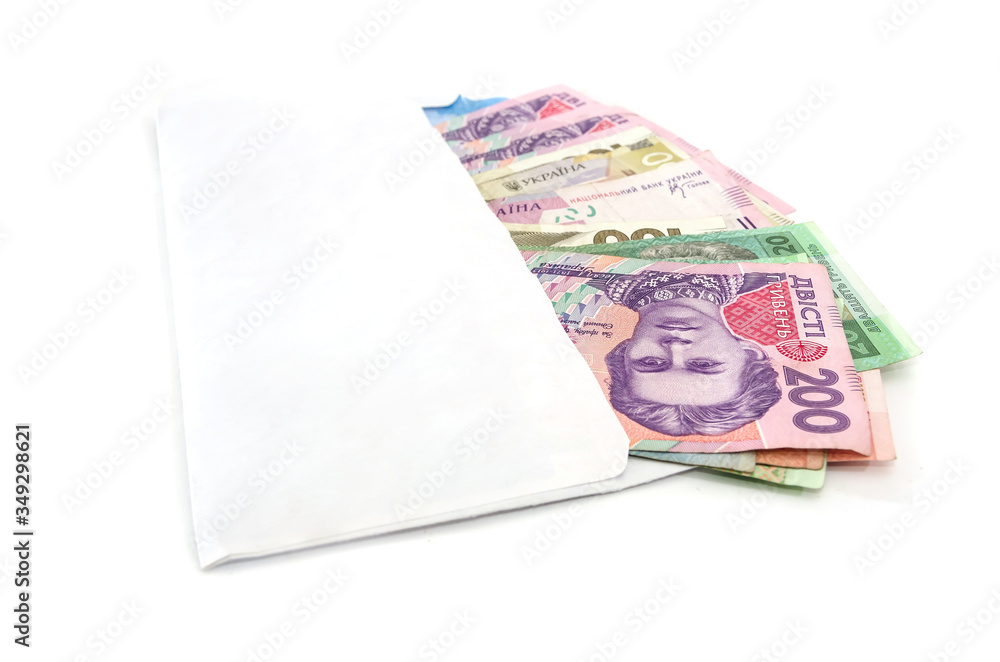 different hryvnias in a white envelope isolated on a white background. different hryvnias in a white envelope isolated on a white background.