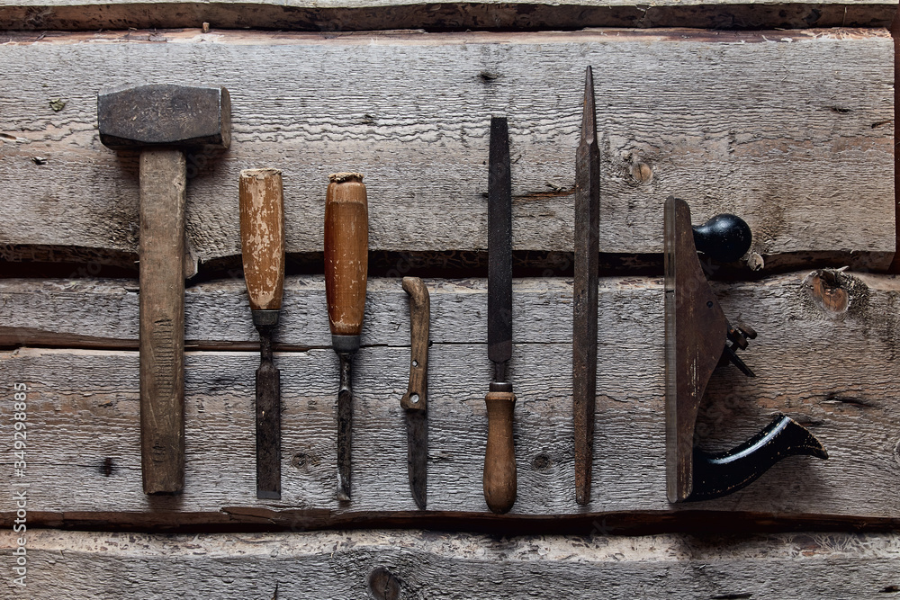 old carpentry tools on wooden background old carpentry tools on wooden background
