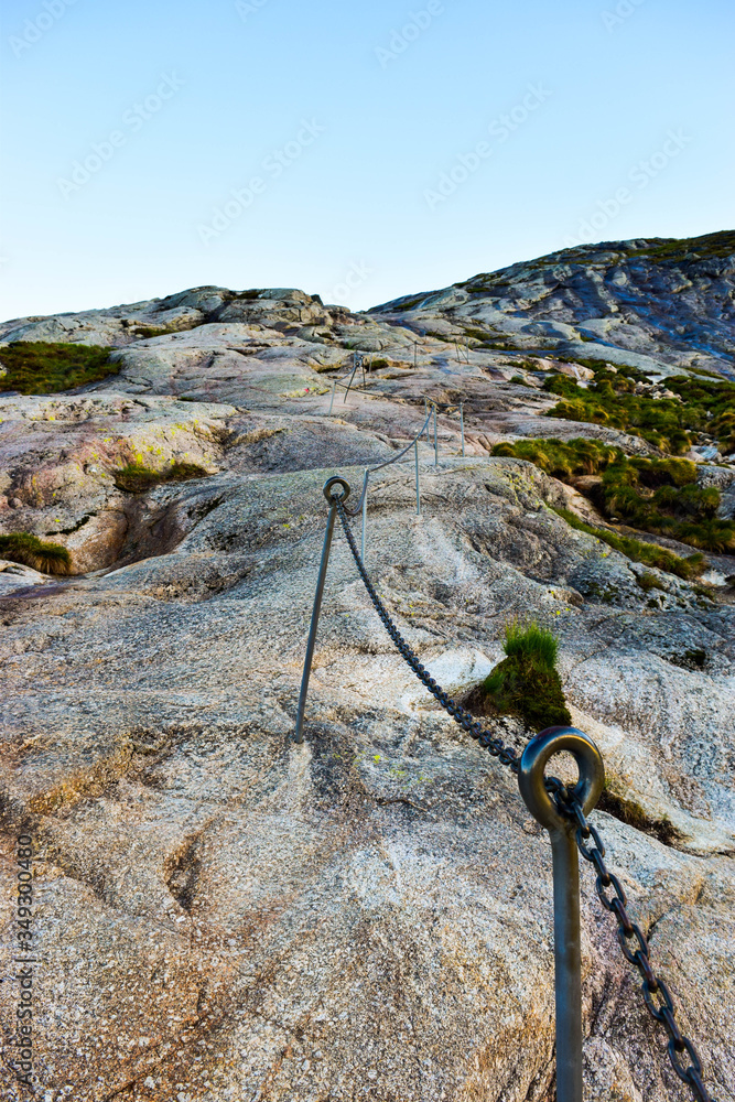Chains on pathway to famous Kjeragbolten to help go up on climb steep cliffs. Norway. Chains on pathway to famous Kjeragbolten to help go up on climb steep cliffs. Norway.