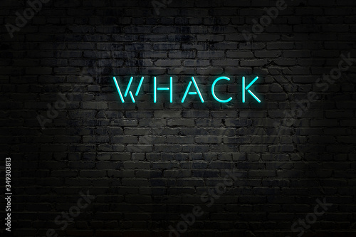 Neon sign with inscription whack against brick wall photo