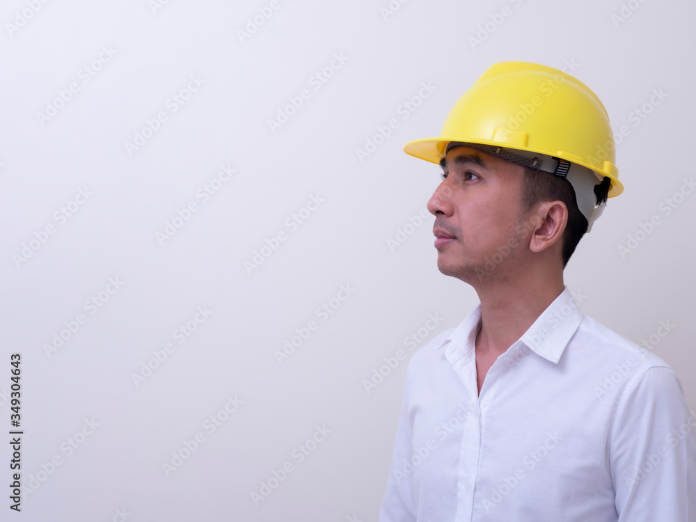engineer with hands crossed wearing yellow helmet on white background engineer with hands crossed wearing yellow helmet on white background