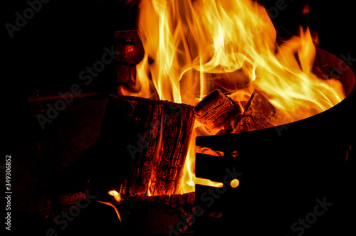 Empty hot barbecue with glowing fire flames on black background