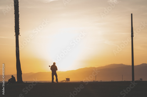silhouette of a man Standing watching the sunset 