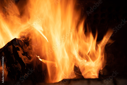 Fire flames on barbecue grill burning raw wood