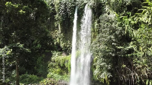 A stunning two levelled waterfall in Lombok, Indonesia. Tiu Kelep Waterfall is surrounded by lush green plants from each side. Long and powerful waterfall. Beauty of the nature.
