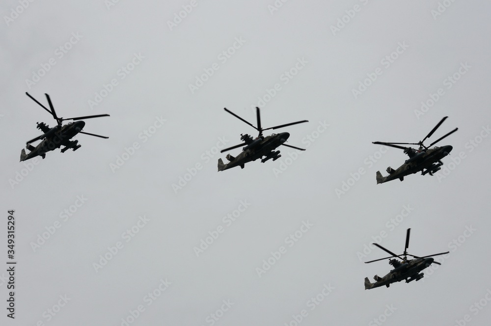 A group of reconnaissance and attack helicopters Ka-52 Alligator (Hokum B) fly in the sky over Red Square during an air parade dedicated to Victory Day in World War II A group of reconnaissance and attack helicopters Ka-52 Alligator (Hokum B) fly in the sky over Red Square during an air parade dedicated to Victory Day in World War II