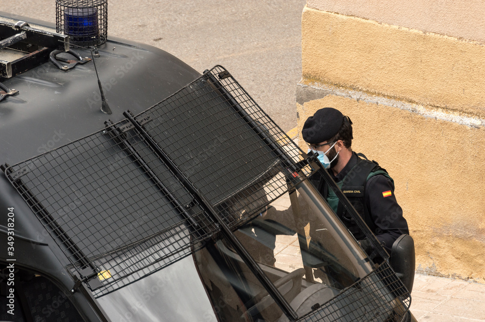 A police officer from the Spanish Civil Guard gets into his police