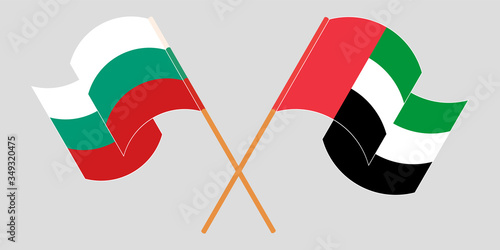 Crossed and waving flags of Bulgaria and the United Arab Emirates
