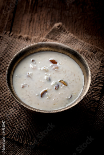 Kheer or Payasam is a type of rice pudding from the Indian subcontinent, made by boiling milk and sugar and is flavoured with dry fruits and nuts, served in metal bowl.