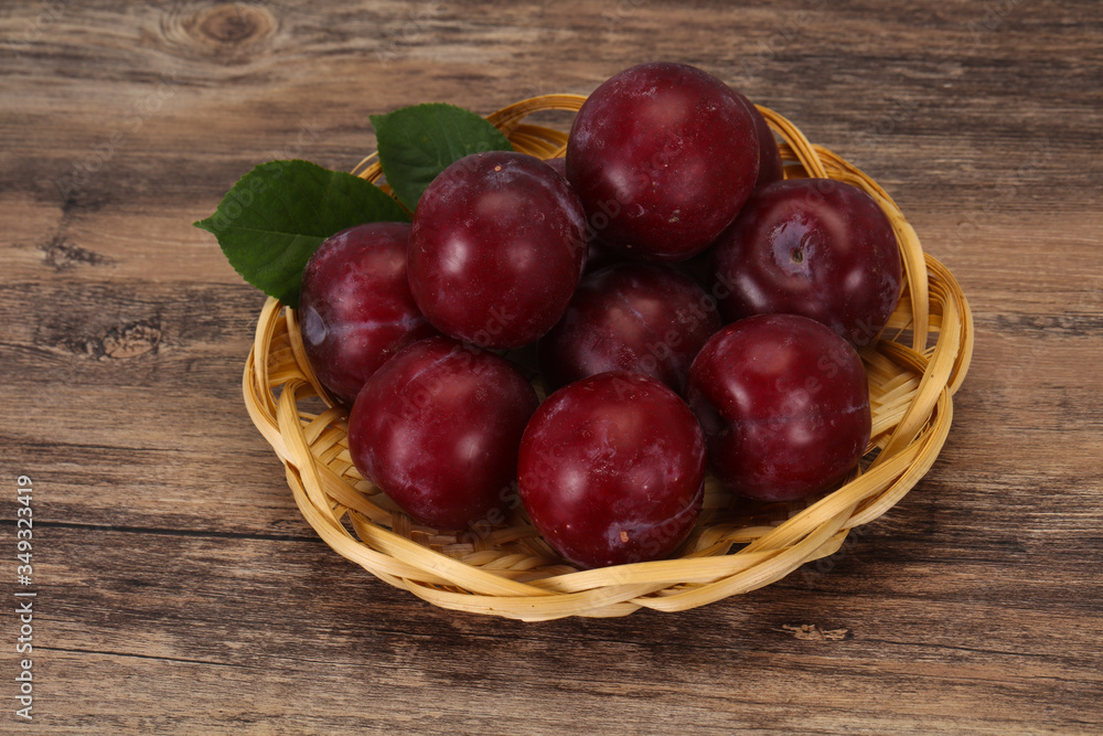Plum heap in the wooden basket Plum heap in the wooden basket