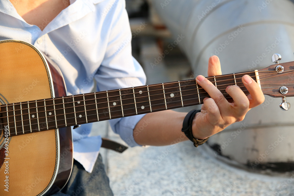 Fototapeta premium a man plays an acoustic guitar
