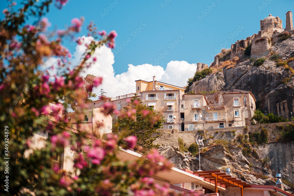 Naklejka premium Old streets of Amantea city in Italy, Calabria. Castello di Amantea on rocky mountains. Sunny summer day