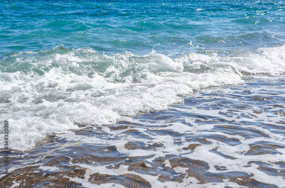 Fototapeta premium Seascape background white waves on blue sea