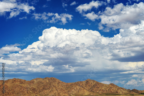 Big thunder clouds over a mountain range in the Mojave Desert in California.