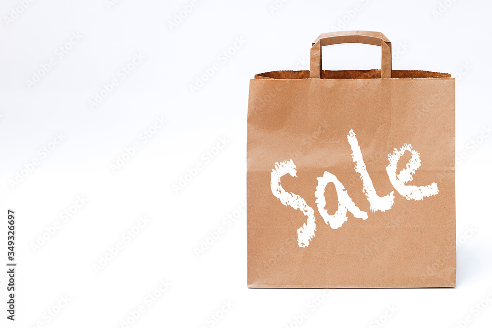 paper bag on a white background, concept of seasonal discounts, black friday, time for shopping, free space on the left paper bag on a white background, concept of seasonal discounts, black friday, time for shopping, free space on the left